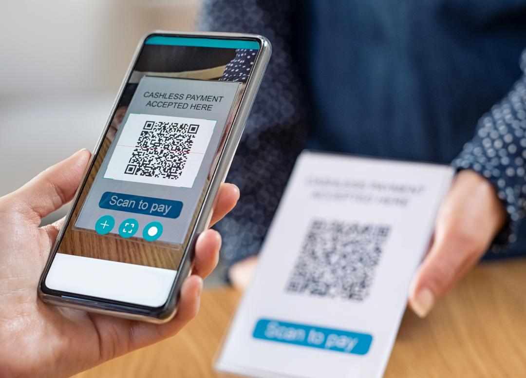 Comprador realizando o pagamento via pix parcelado por QR code através do seu smartphone.